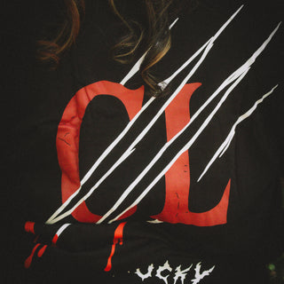 Black t-shirt with red and white design on a dark background