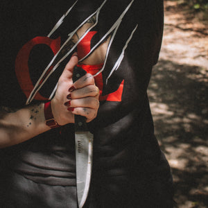 Person holding a knife with a dark